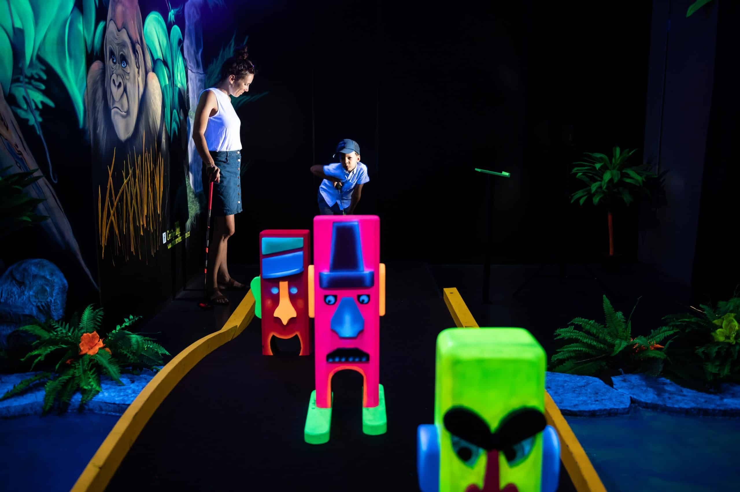 Famille jouant au mini-golf fluo Laser Force Drummondville